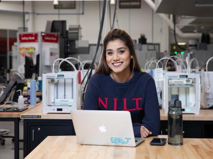 Photo of female student using a laptop