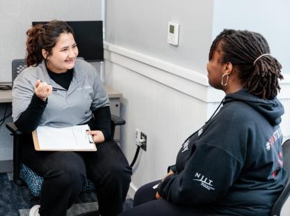 photo of a Peer Wellness Coach meeting with a fellow student