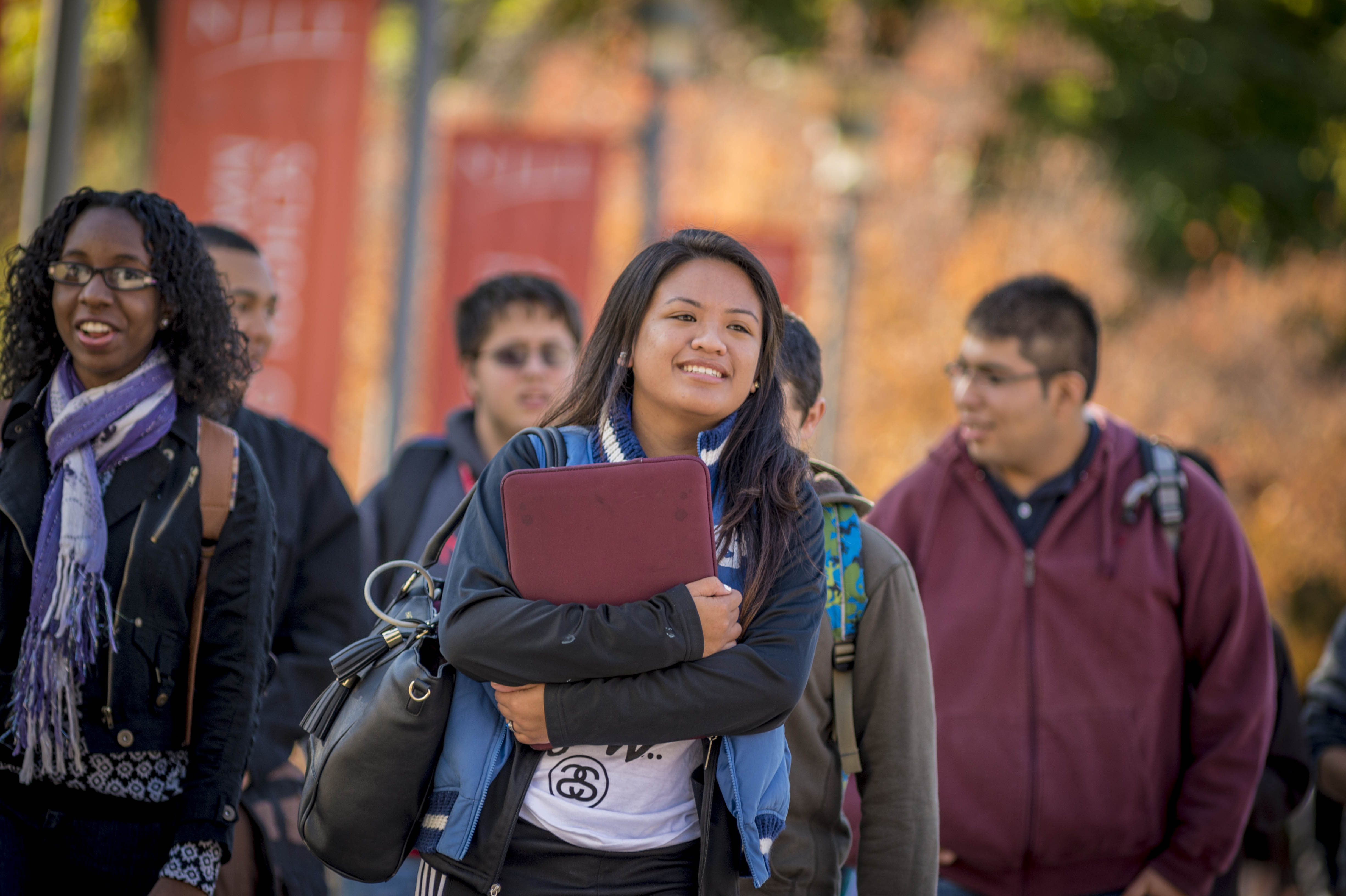 Female student walking with books on campus