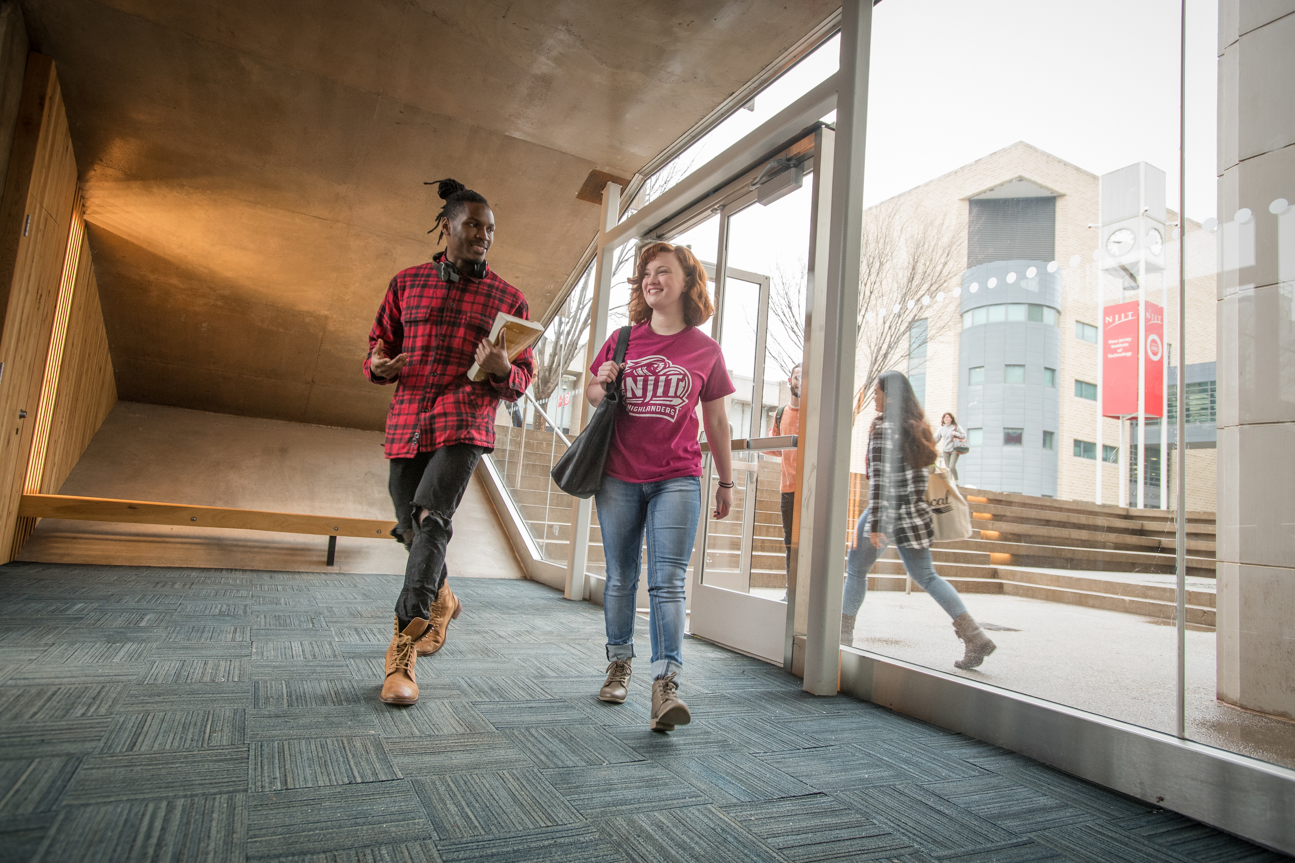 Male and female student walking in a hallway